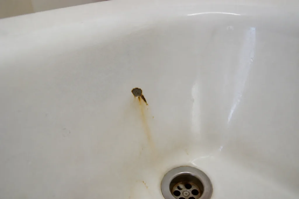 Bathtub rust chips and stains before repair